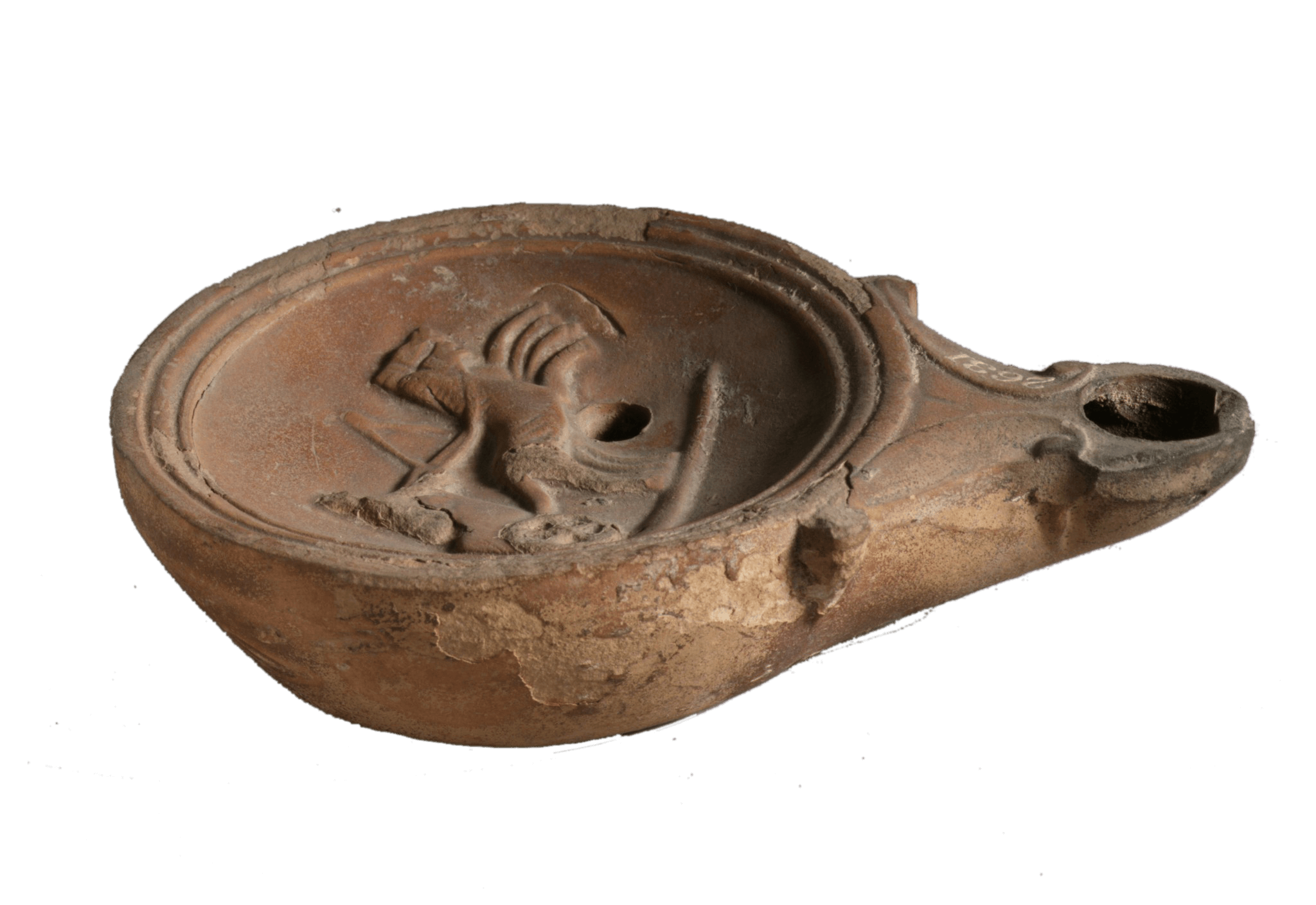 A ceramic oil lamp. It is round with a hole like a spout.