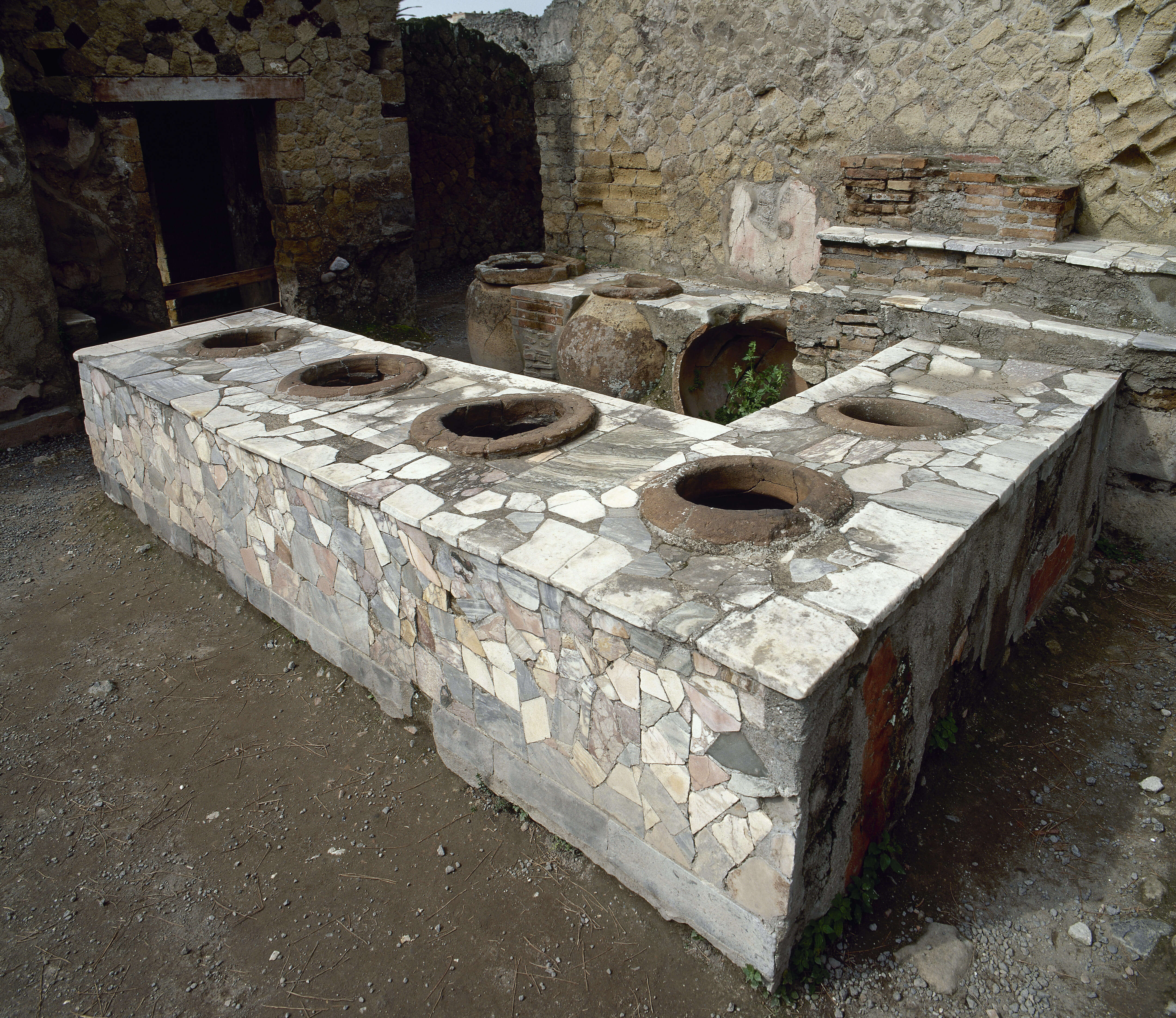 A bar covered in a mosaic pattern of large bits of stone.